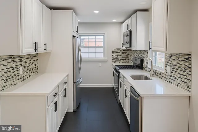 a kitchen with a sink stove and refrigerator
