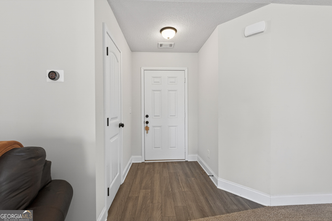 142 Rolling Wds Lane, Unit 29 Colbert, GA 30628 - Photo 18 of 34 a view of a hallway with wooden floor