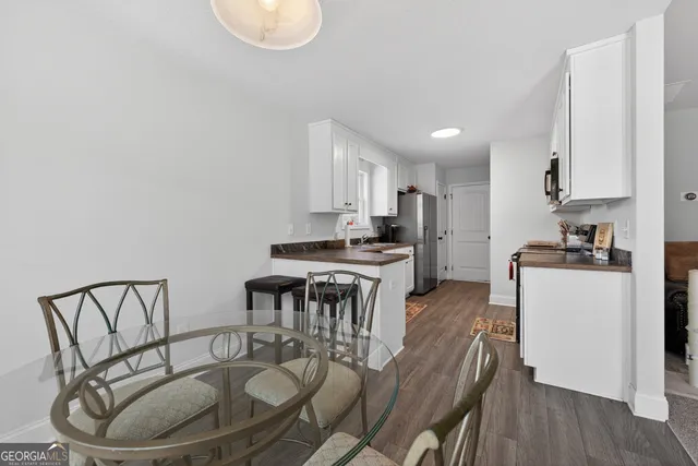 a kitchen with kitchen island a white cabinets and wooden floor