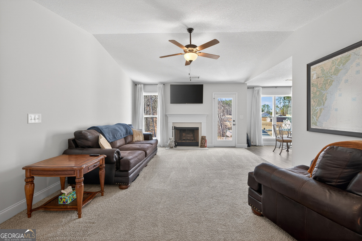 142 Rolling Wds Lane, Unit 29 Colbert, GA 30628 - Photo 2 of 34 a living room with furniture and a fireplace