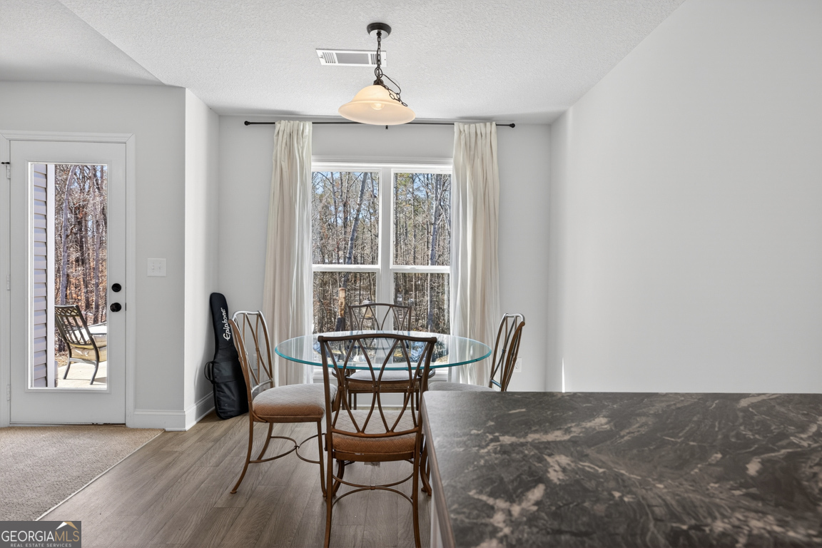 142 Rolling Wds Lane, Unit 29 Colbert, GA 30628 - Photo 24 of 34 a view of a dining room with furniture and wooden floor