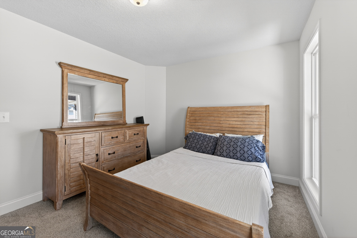 142 Rolling Wds Lane, Unit 29 Colbert, GA 30628 - Photo 25 of 34 a bedroom with a bed and a dresser