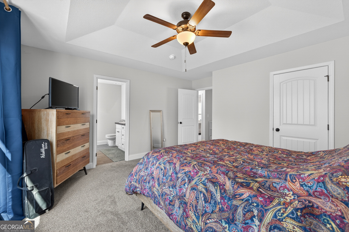 142 Rolling Wds Lane, Unit 29 Colbert, GA 30628 - Photo 30 of 34 a bedroom with a bed and a flat tv screen on dresser