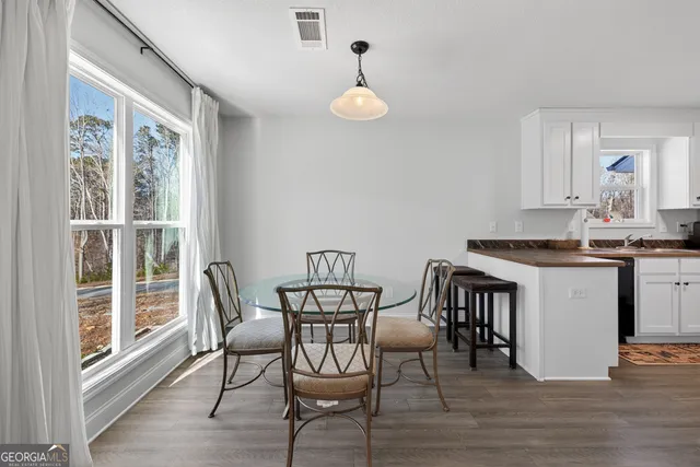 a view of a dining room with furniture and wooden floor