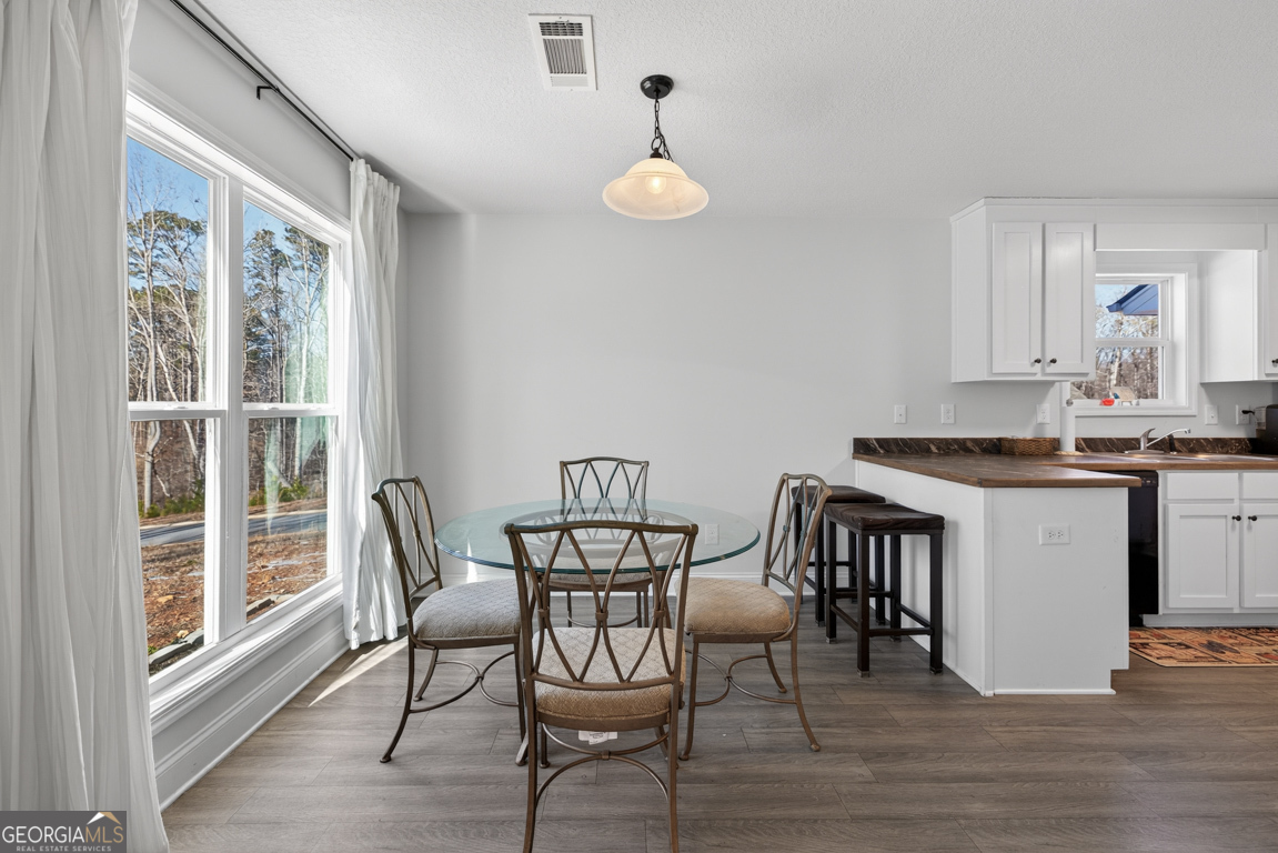 142 Rolling Wds Lane, Unit 29 Colbert, GA 30628 - Photo 3 of 34 a view of a dining room with furniture and wooden floor