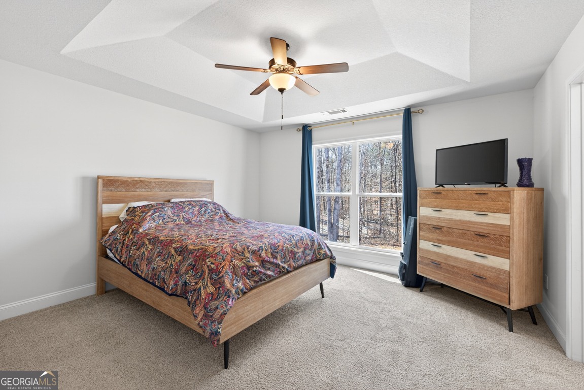 142 Rolling Wds Lane, Unit 29 Colbert, GA 30628 - Photo 5 of 34 a bedroom with a bed and a flat tv screen