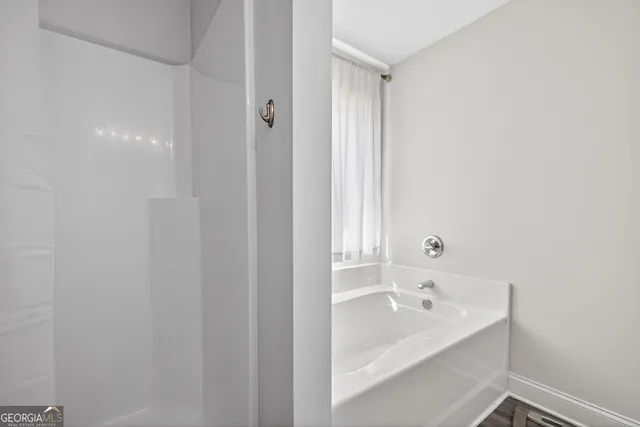 a bathroom with a bathtub and shower