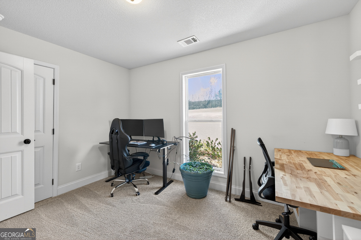 142 Rolling Wds Lane, Unit 29 Colbert, GA 30628 - Photo 10 of 34 a view of a workspace with furniture and a window