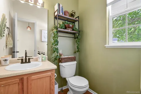 a bathroom with a sink a toilet and a mirror