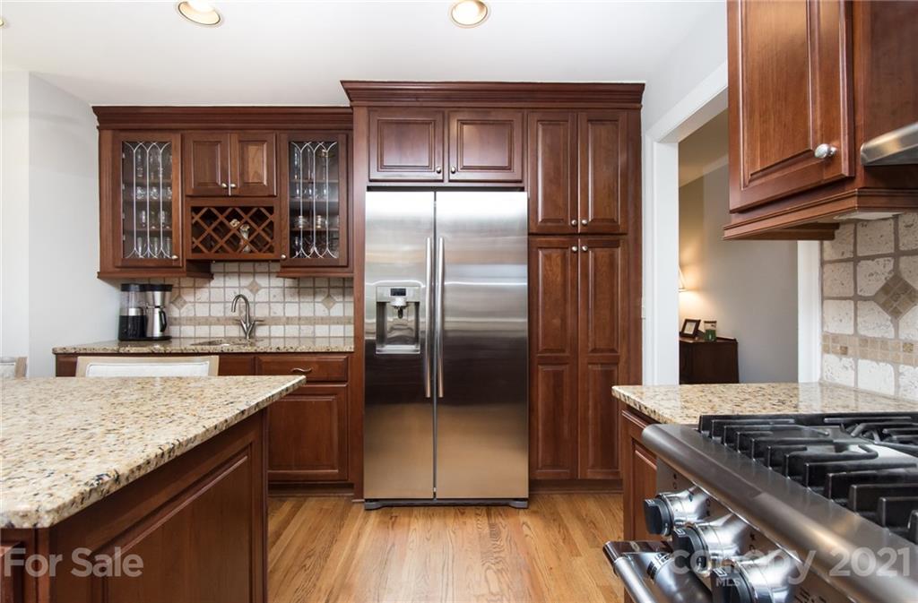 6955 Old Providence Road Charlotte, NC 28226 - Photo 11 of 44 a kitchen with granite countertop a refrigerator stove and oven