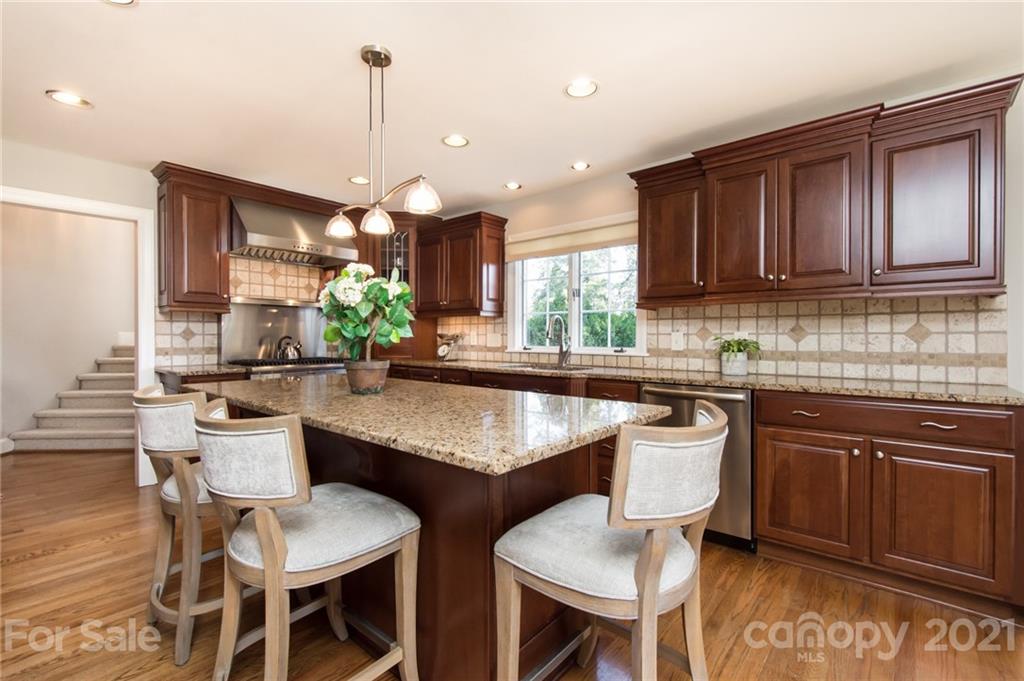 6955 Old Providence Road Charlotte, NC 28226 - Photo 12 of 44 a kitchen with a dining table chairs and a sink