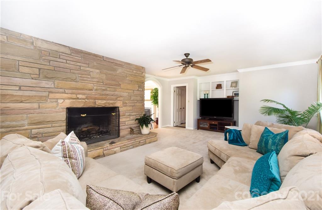 6955 Old Providence Road Charlotte, NC 28226 - Photo 16 of 44 a living room with furniture a fireplace and a flat screen tv