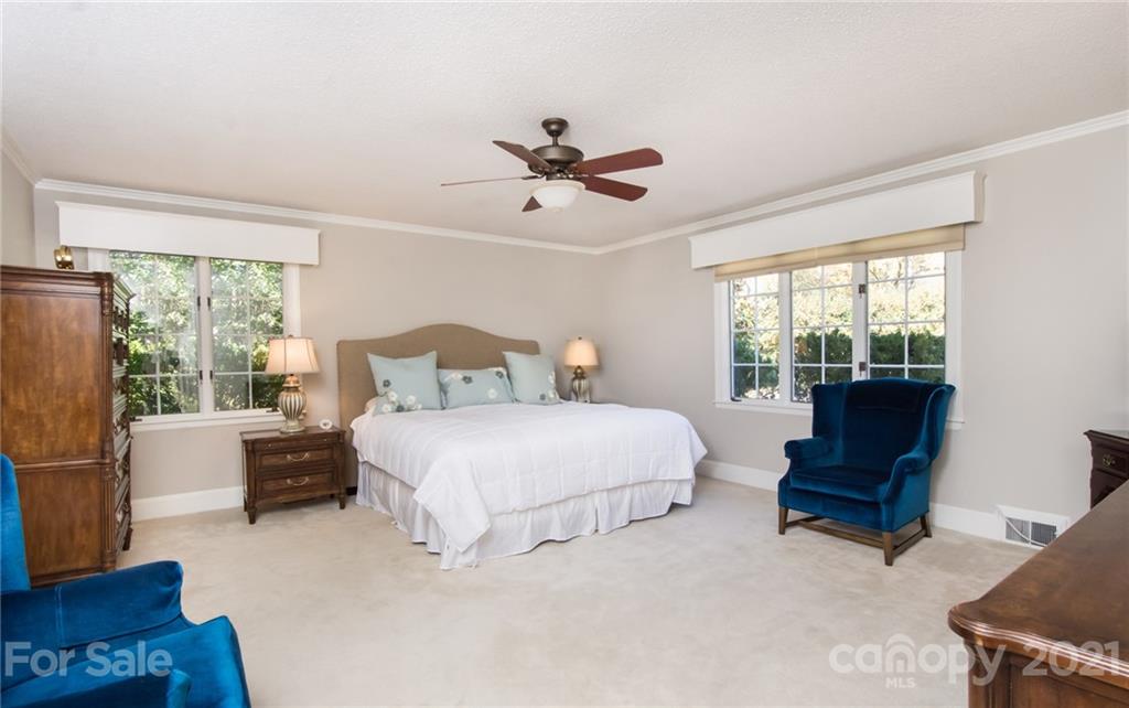 6955 Old Providence Road Charlotte, NC 28226 - Photo 18 of 44 a bedroom with a bed and wooden floor