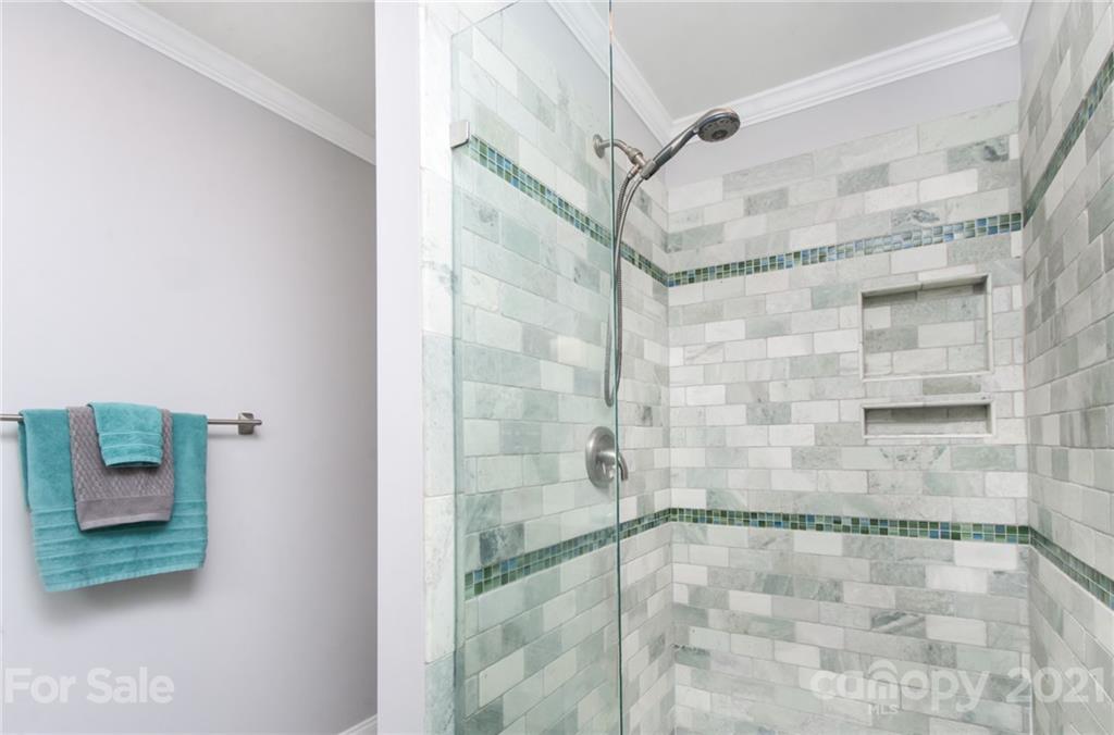 6955 Old Providence Road Charlotte, NC 28226 - Photo 19 of 44 a bathroom with a glass shower door