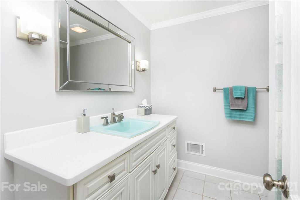 6955 Old Providence Road Charlotte, NC 28226 - Photo 20 of 44 a bathroom with a sink and a mirror