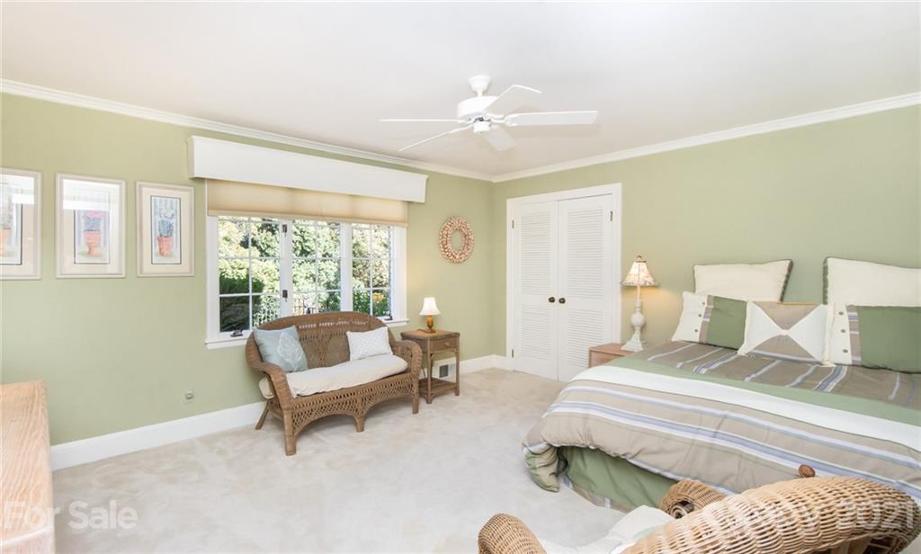 6955 Old Providence Road Charlotte, NC 28226 - Photo 22 of 44 a bedroom with a bed and a chandelier