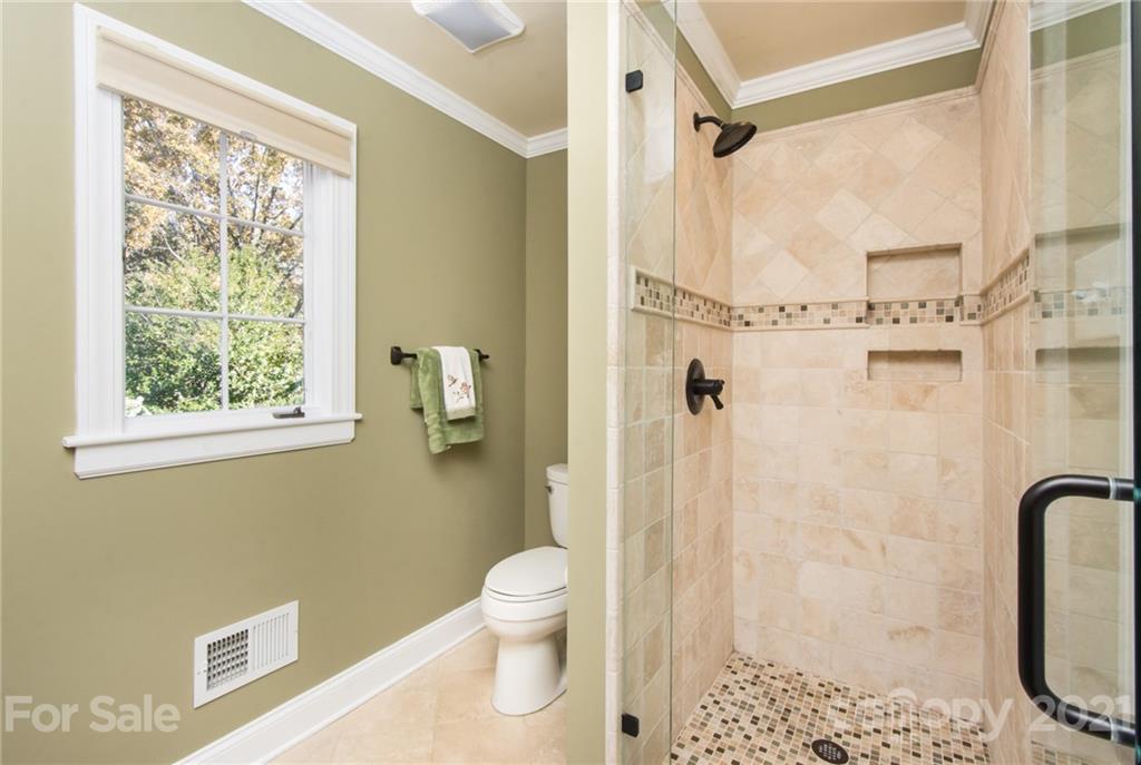 6955 Old Providence Road Charlotte, NC 28226 - Photo 23 of 44 a bathroom with a shower a toilet and a shower
