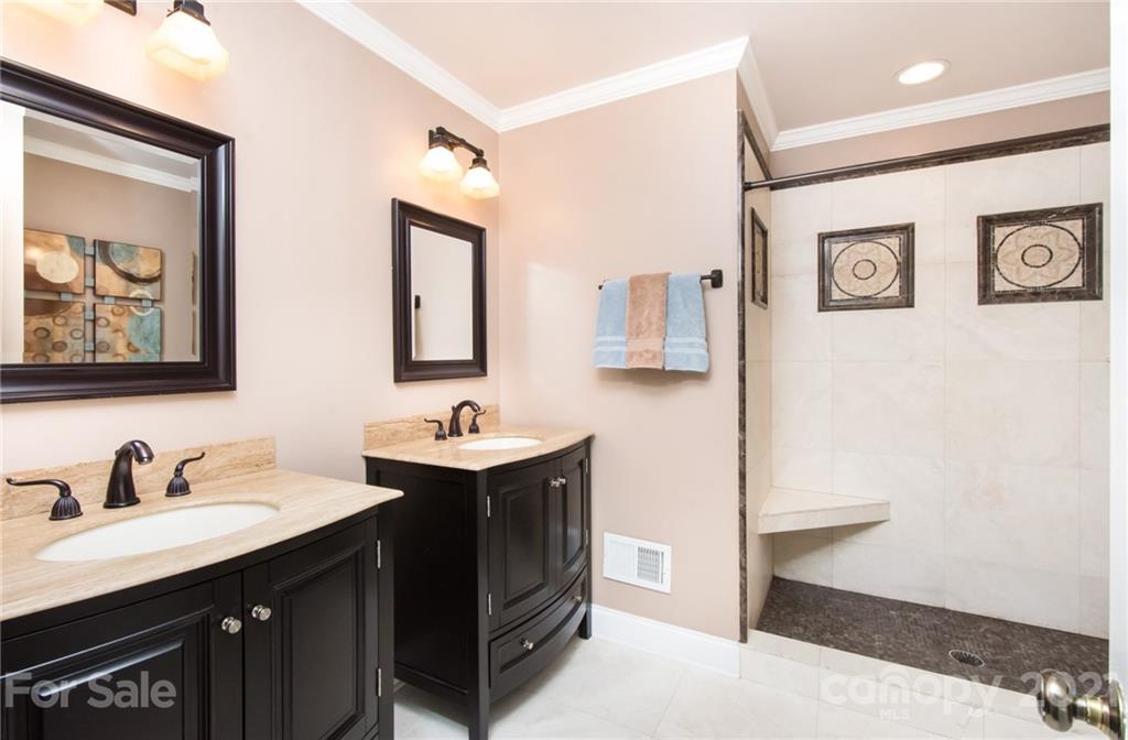 6955 Old Providence Road Charlotte, NC 28226 - Photo 26 of 44 a bathroom with a sink and a mirror