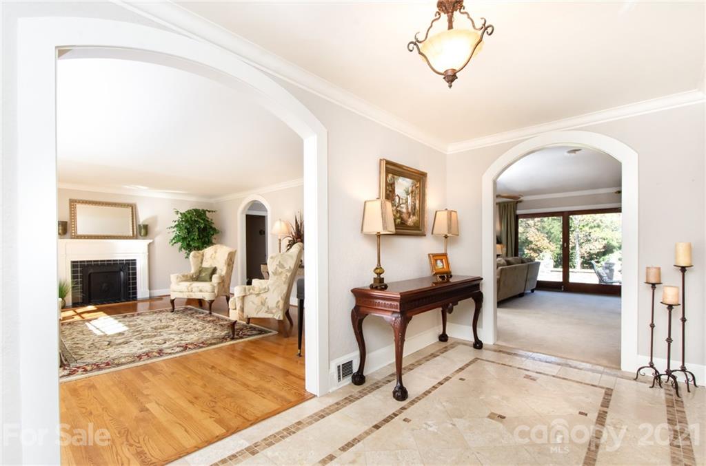 6955 Old Providence Road Charlotte, NC 28226 - Photo 5 of 44 a living room with furniture a fireplace and a flat screen tv