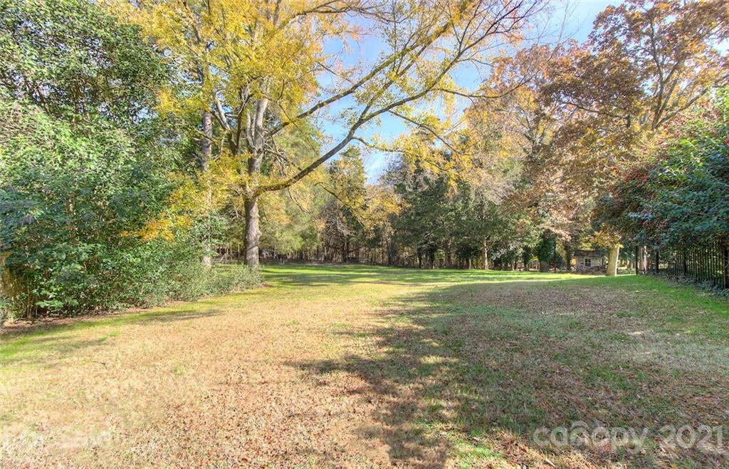 6955 Old Providence Road Charlotte, NC 28226 - Photo 41 of 44 a view of a field with trees in the background