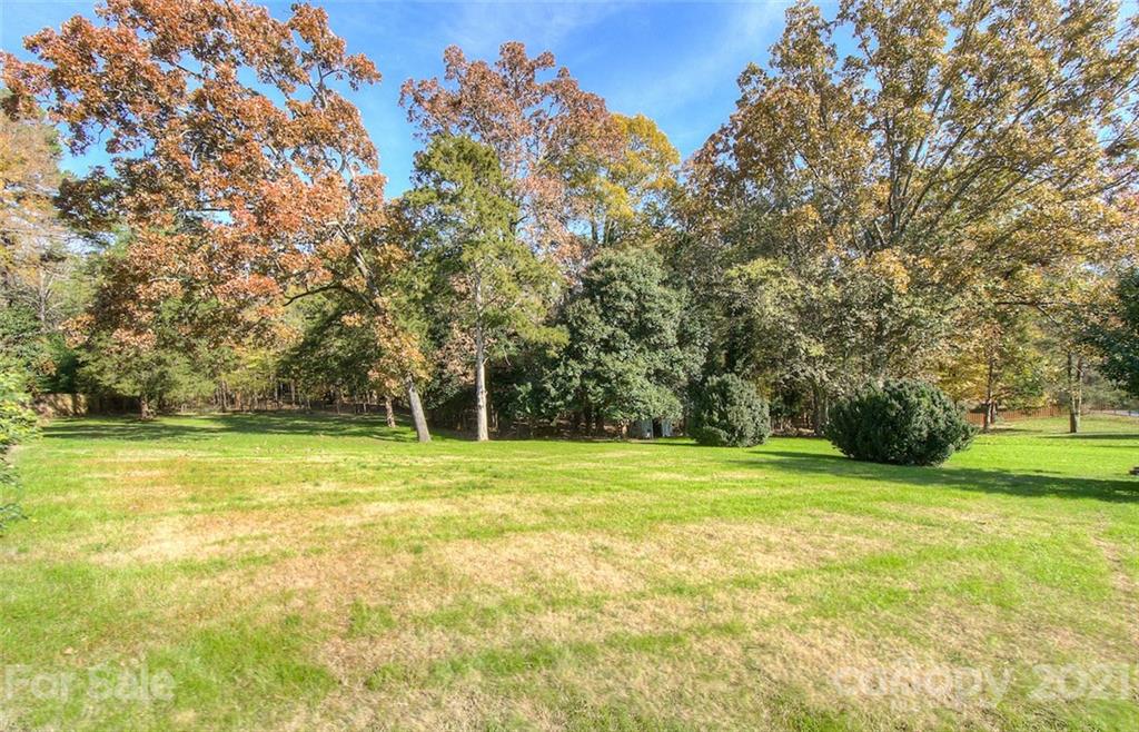 6955 Old Providence Road Charlotte, NC 28226 - Photo 44 of 44 a view of a grassy field with trees
