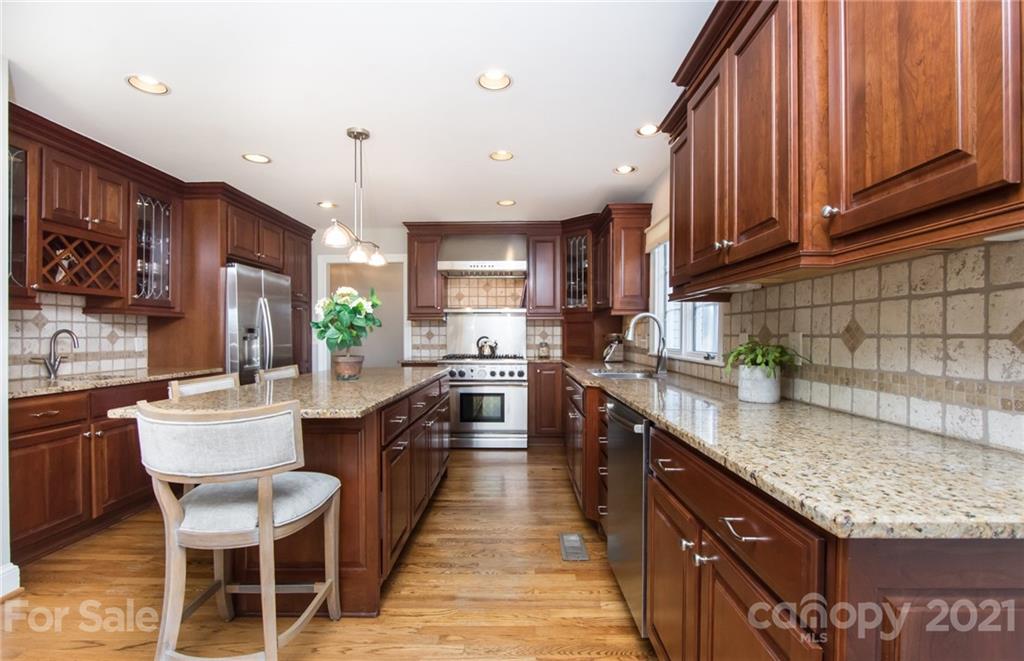 6955 Old Providence Road Charlotte, NC 28226 - Photo 10 of 44 a kitchen with granite countertop a sink a counter top space appliances and cabinets