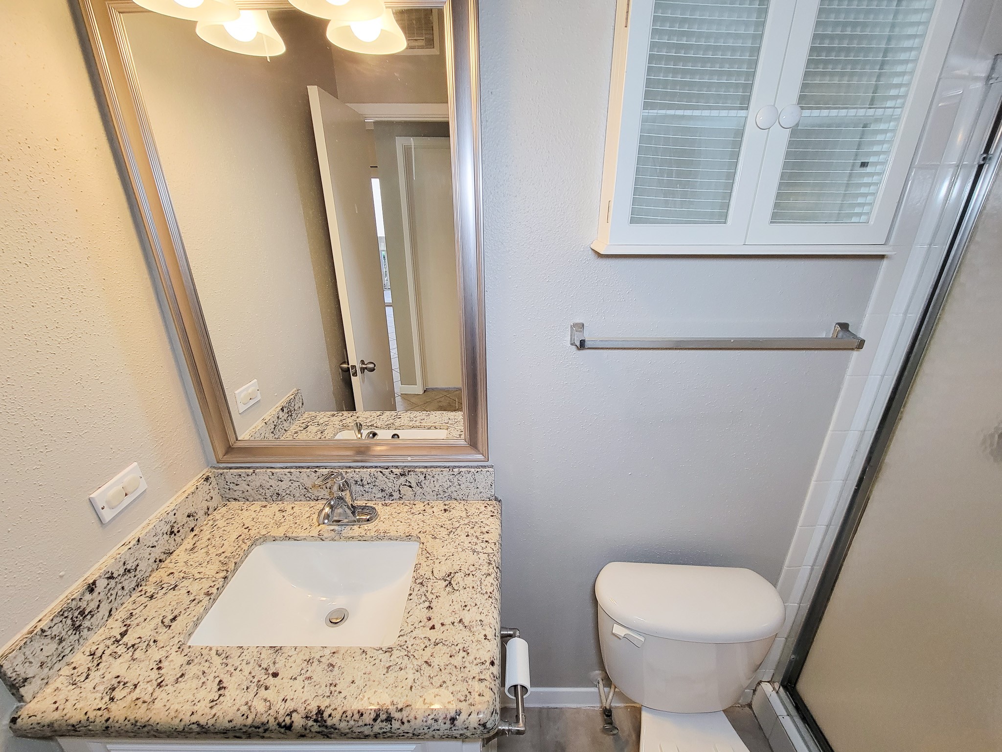 4041 Drake Street, Unit 116 Houston, TX 77005 - Photo 21 of 27 a bathroom with a toilet sink and mirror