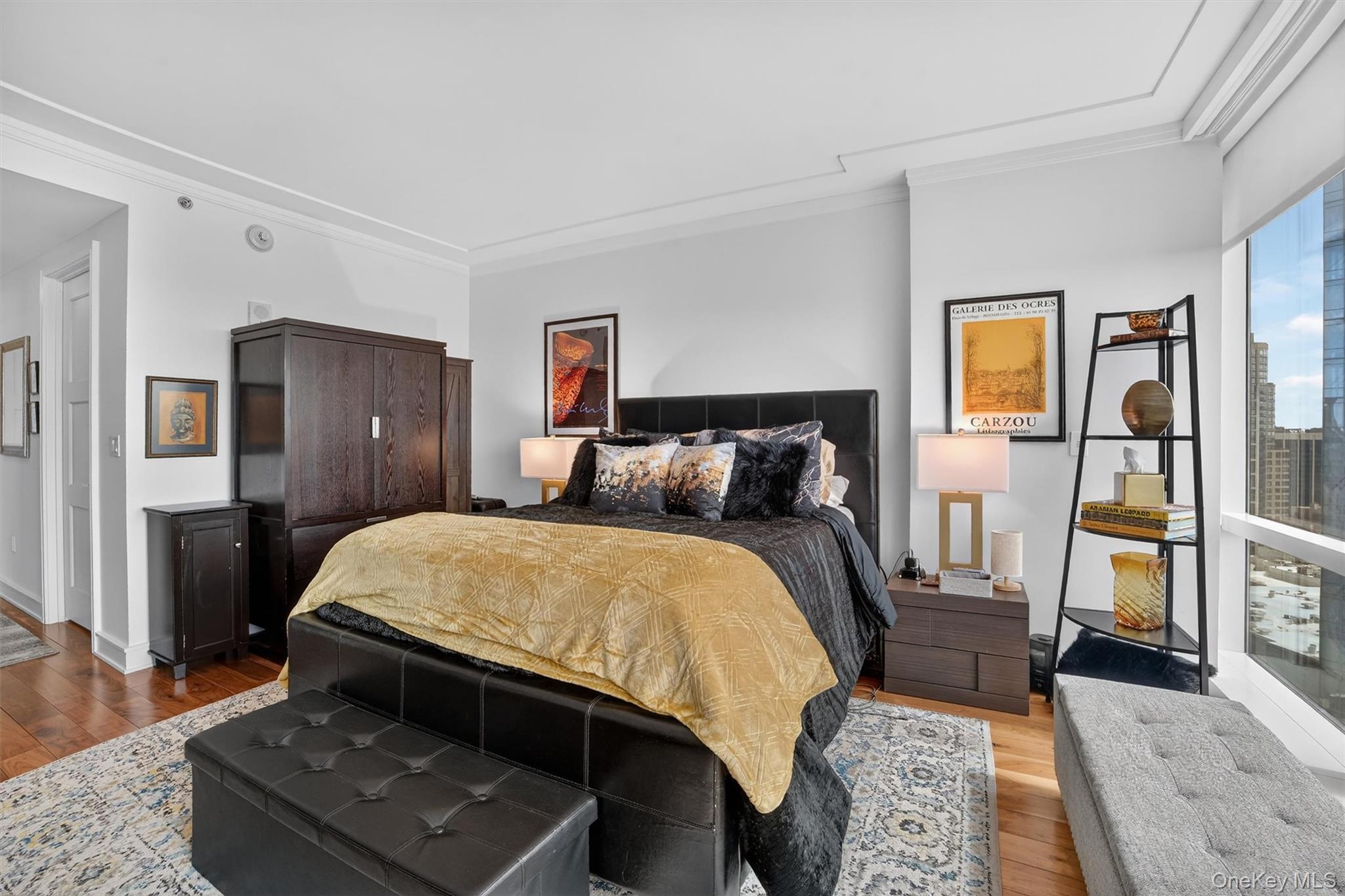 5 Renaissance Square, Unit 26E White Plains, NY 10601 - Photo 15 of 21 a bed room with a bed and wooden floor