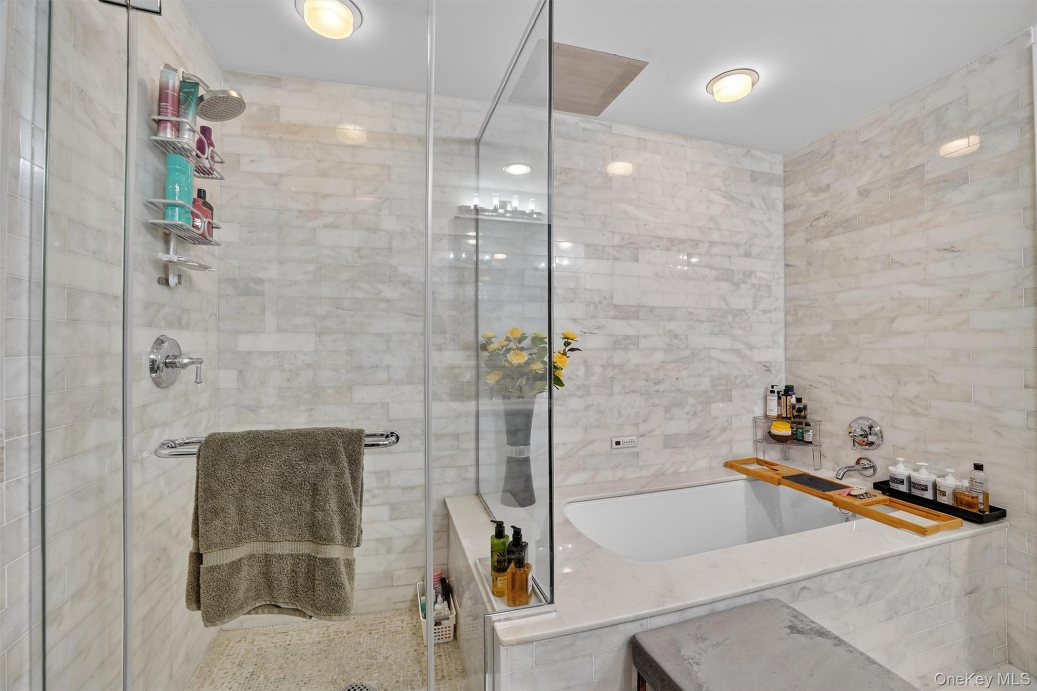 5 Renaissance Square, Unit 26E White Plains, NY 10601 - Photo 17 of 21 a bathroom with a tub and a shower