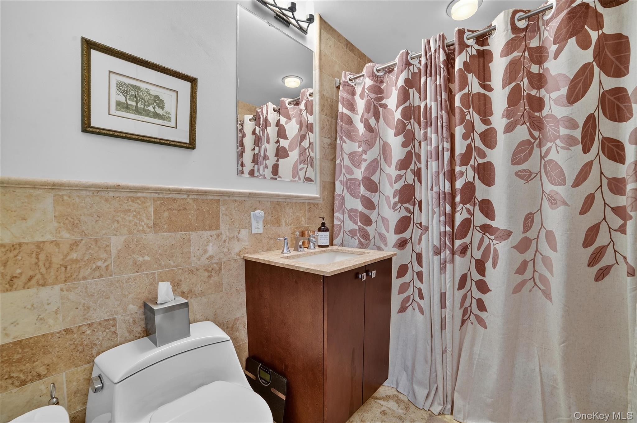 5 Renaissance Square, Unit 26E White Plains, NY 10601 - Photo 19 of 21 a bathroom with a sink and mirror with toilet