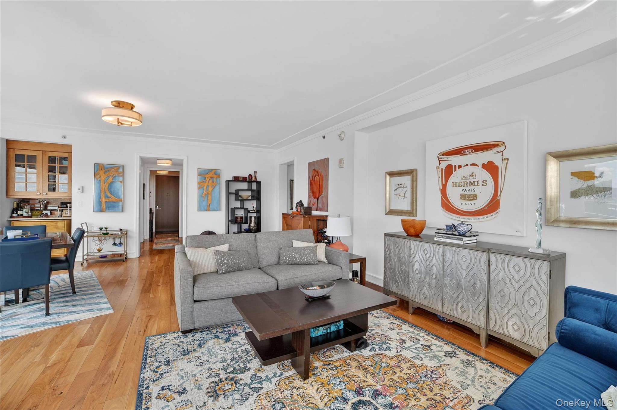 5 Renaissance Square, Unit 26E White Plains, NY 10601 - Photo 3 of 21 a living room with furniture a rug and a window