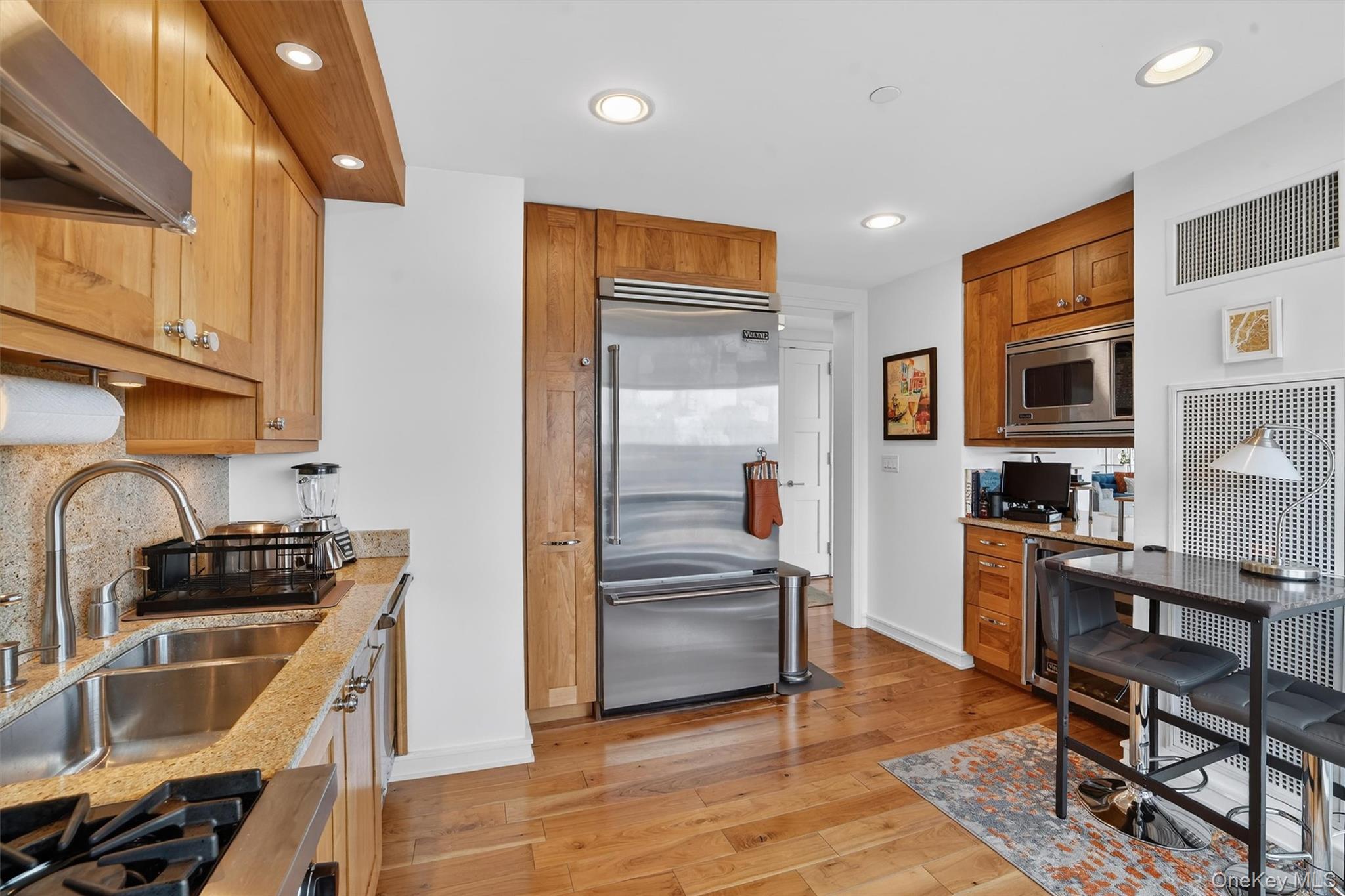 5 Renaissance Square, Unit 26E White Plains, NY 10601 - Photo 8 of 21 a kitchen with granite countertop a refrigerator stove top oven and sink