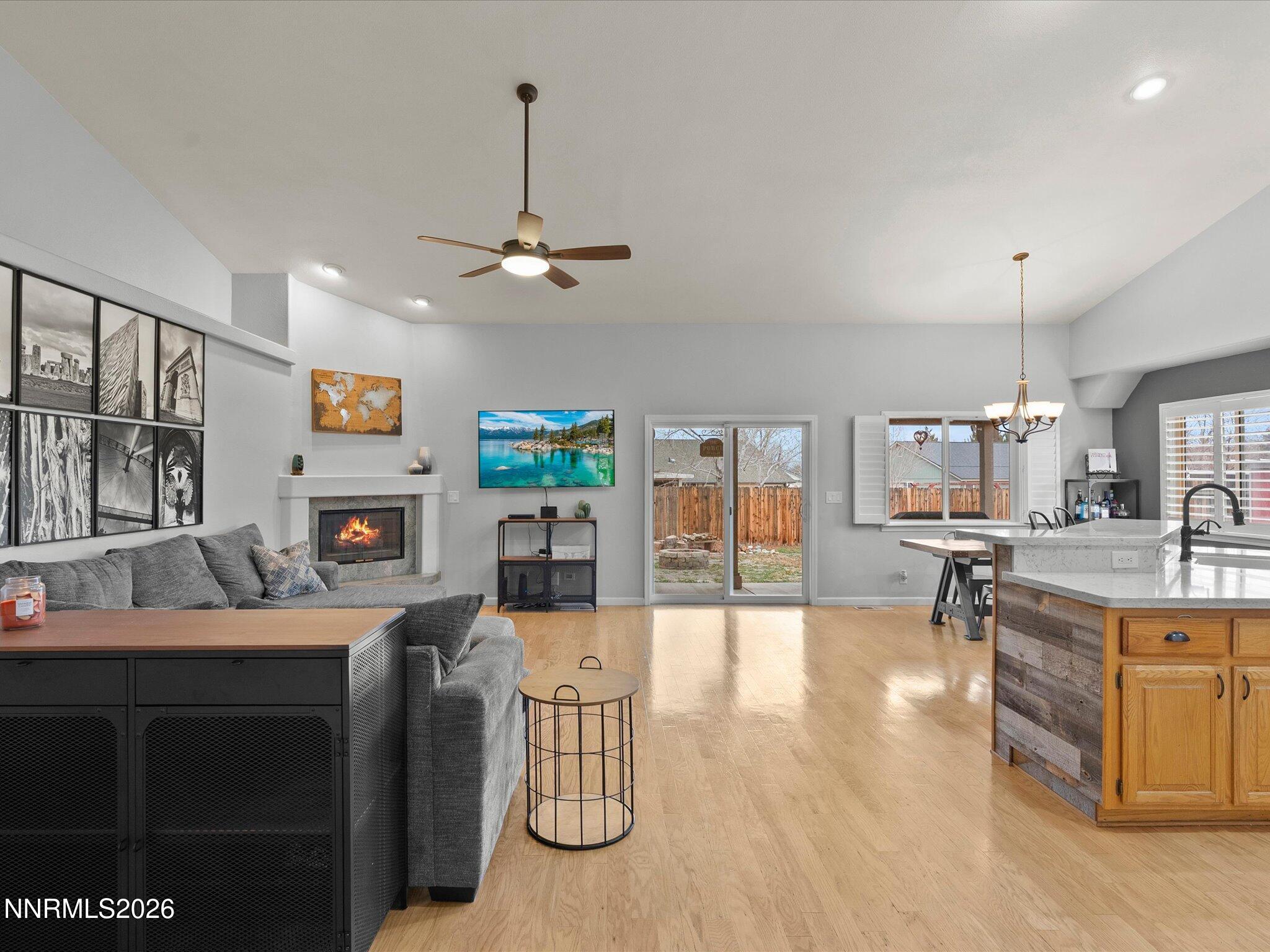 112 Alexander Court Fernley, NV 89408 - Photo 15 of 61 a living room with furniture a dining table and a fireplace