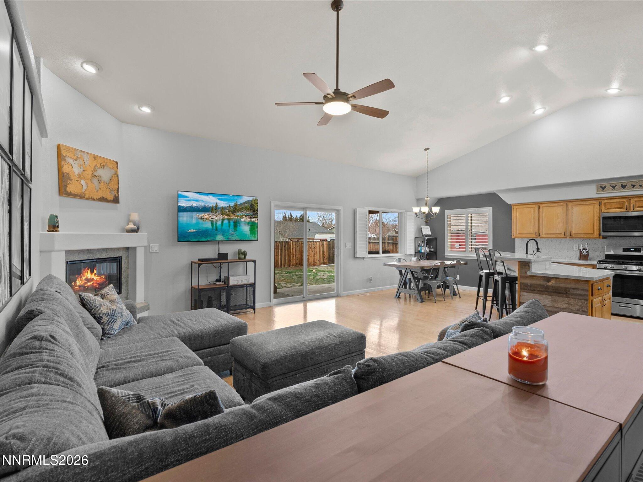 112 Alexander Court Fernley, NV 89408 - Photo 17 of 61 a living room with furniture a fireplace and a flat screen tv