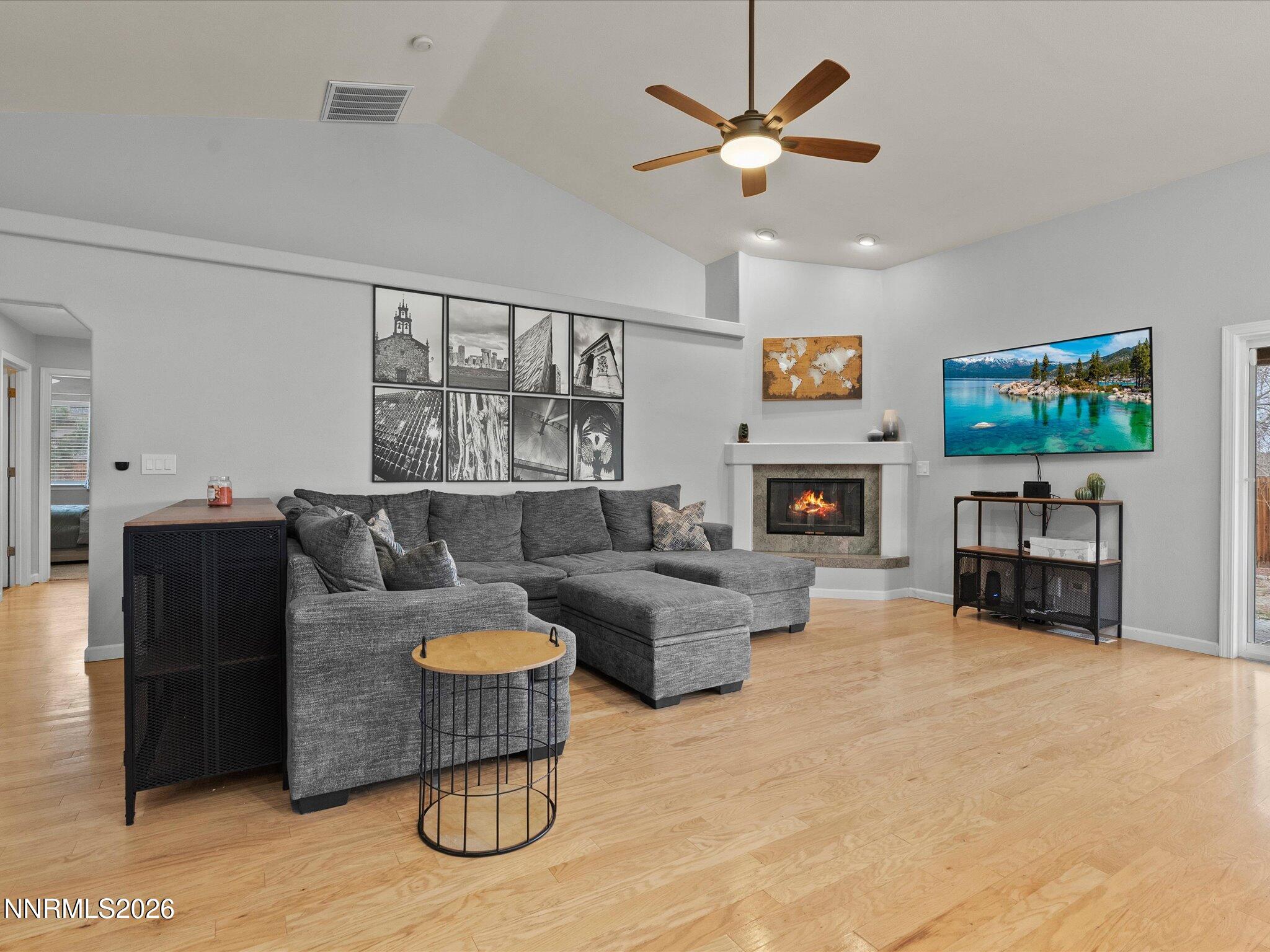 112 Alexander Court Fernley, NV 89408 - Photo 18 of 61 a living room with furniture a fireplace and a flat screen tv