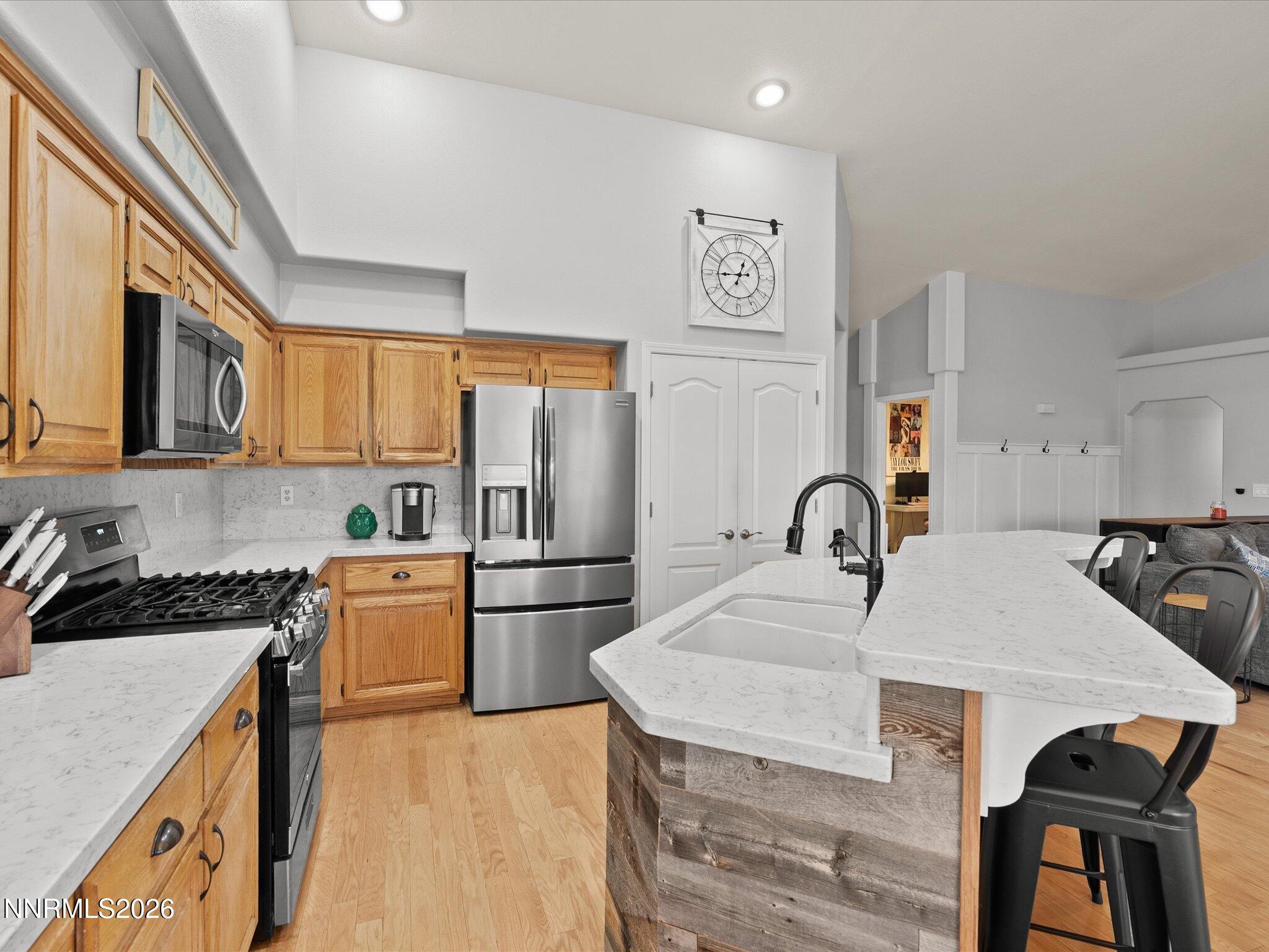 112 Alexander Court Fernley, NV 89408 - Photo 24 of 61 a kitchen with stainless steel appliances granite countertop a stove a sink a refrigerator and a refrigerator