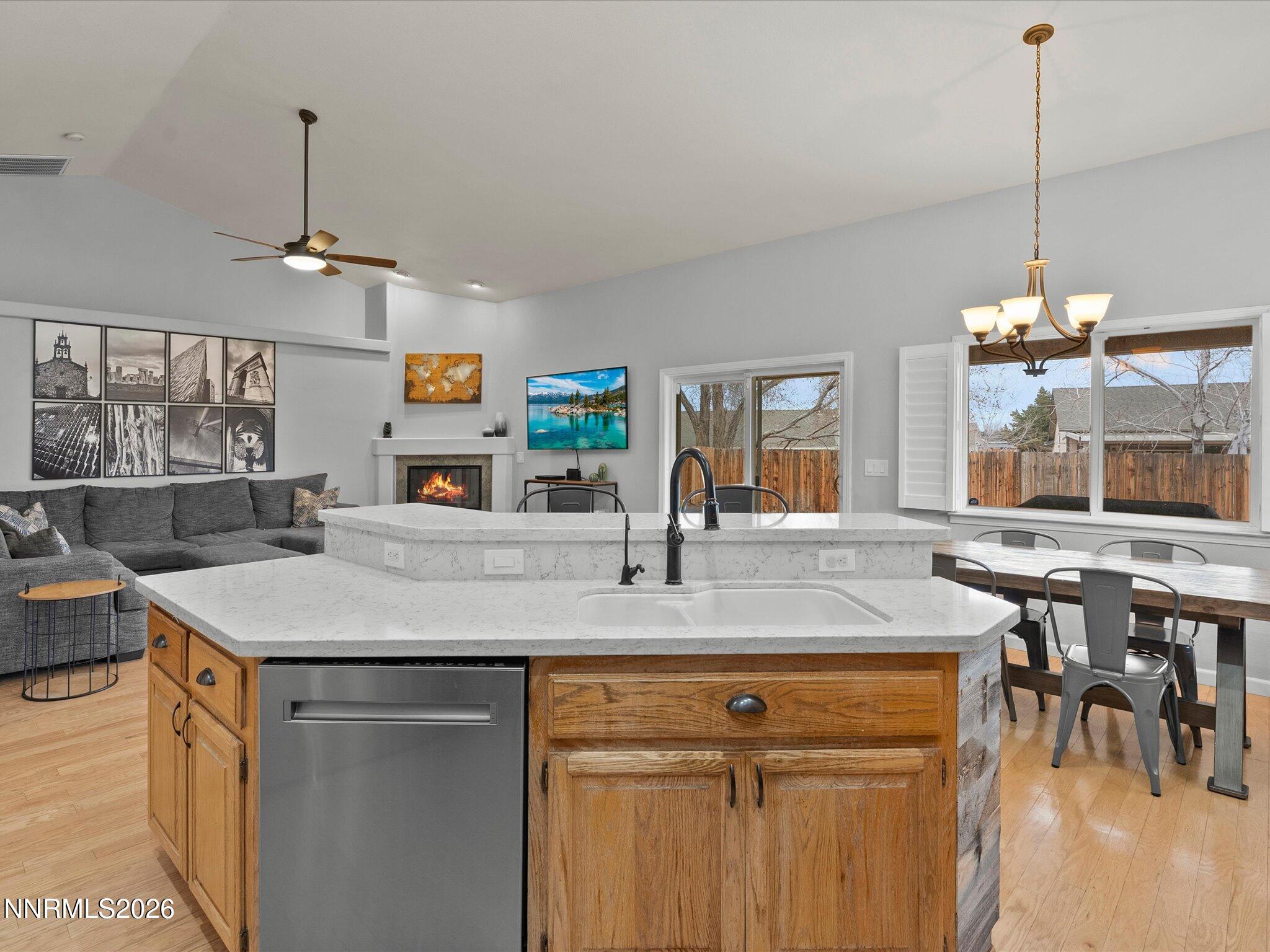 112 Alexander Court Fernley, NV 89408 - Photo 27 of 61 a view of a kitchen counter top space a sink stainless steel appliances and a chandelier