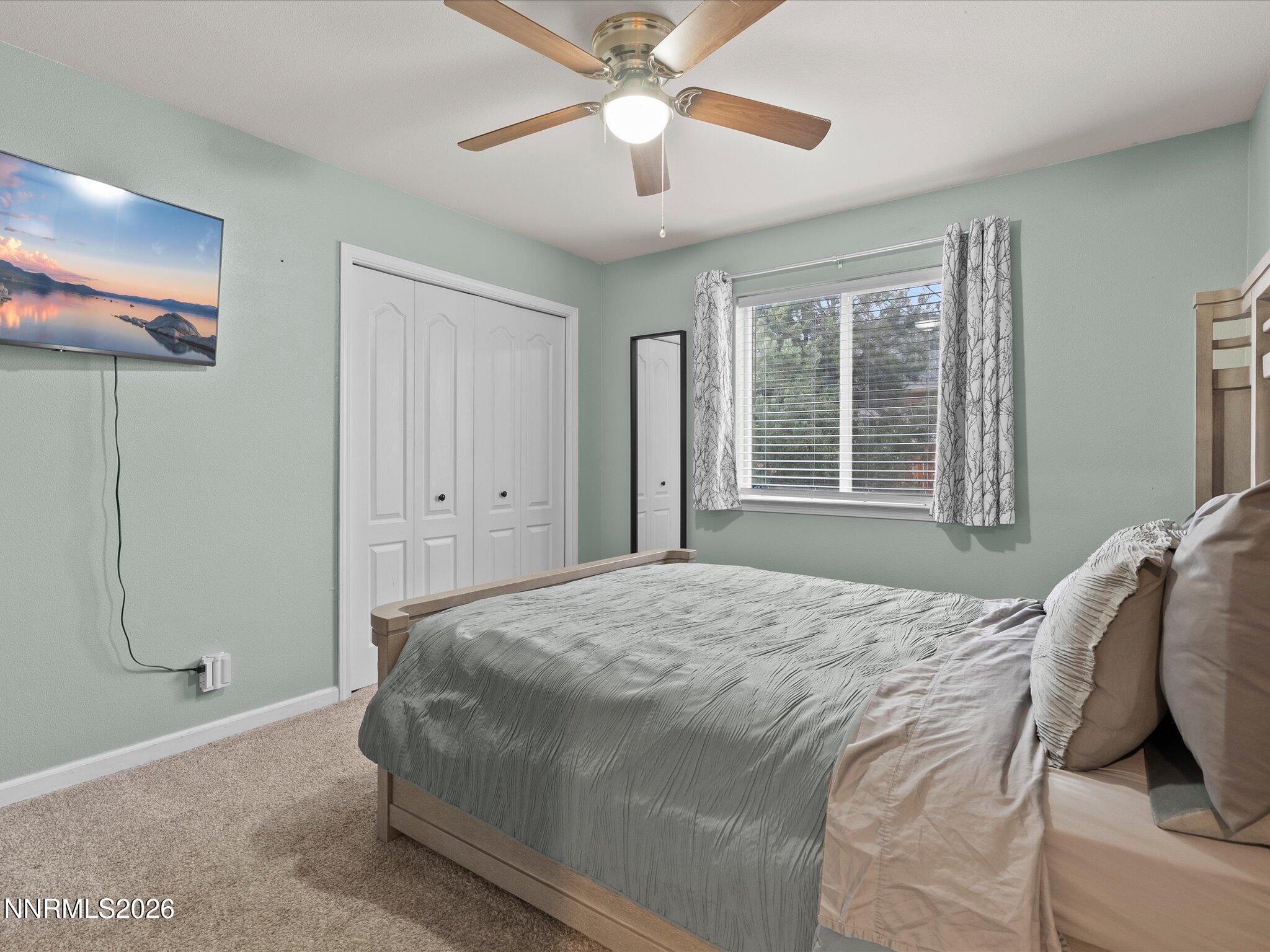 112 Alexander Court Fernley, NV 89408 - Photo 28 of 61 a bedroom with a bed and a chandelier
