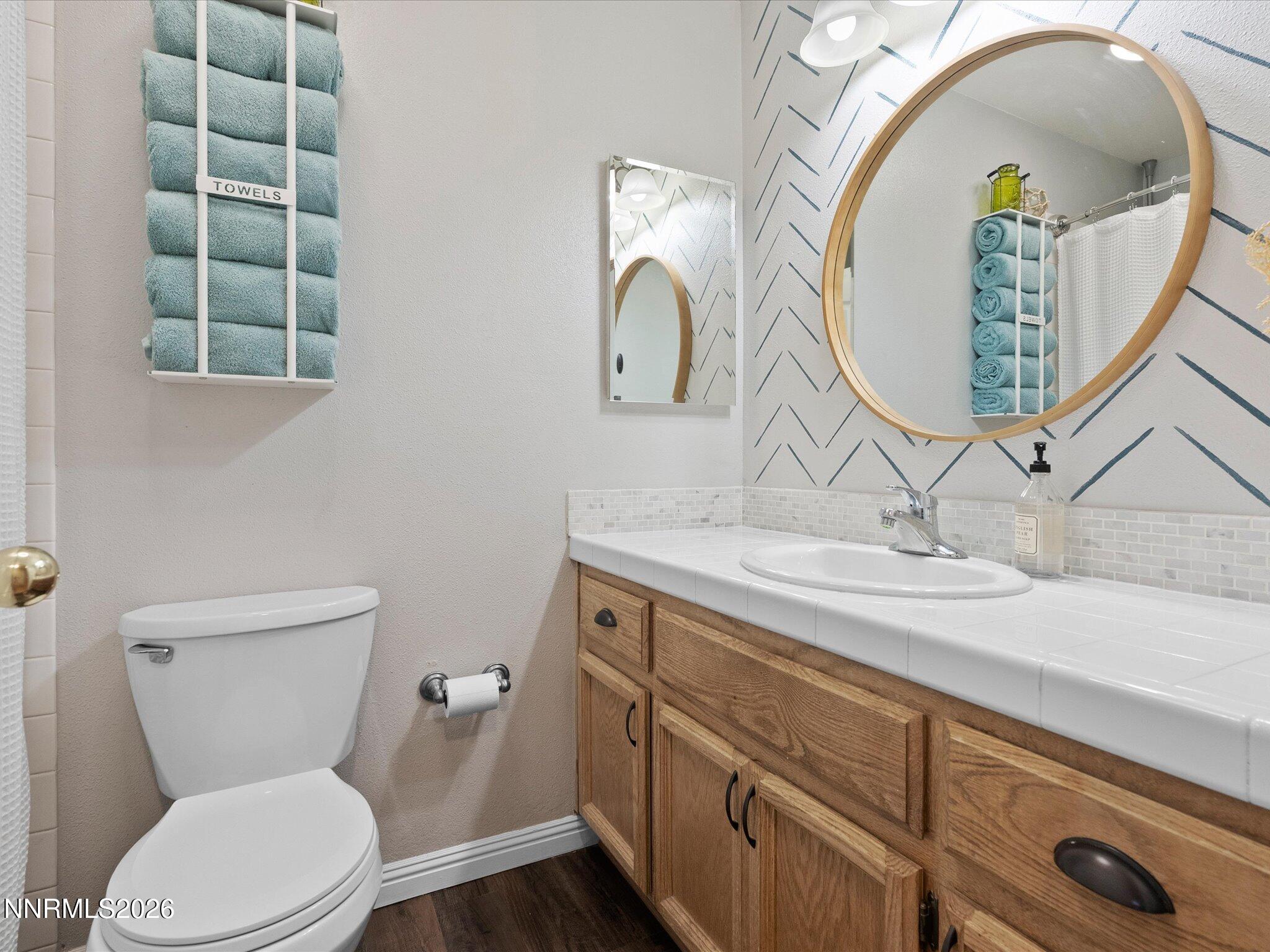 112 Alexander Court Fernley, NV 89408 - Photo 30 of 61 a bathroom with a toilet a sink and mirror
