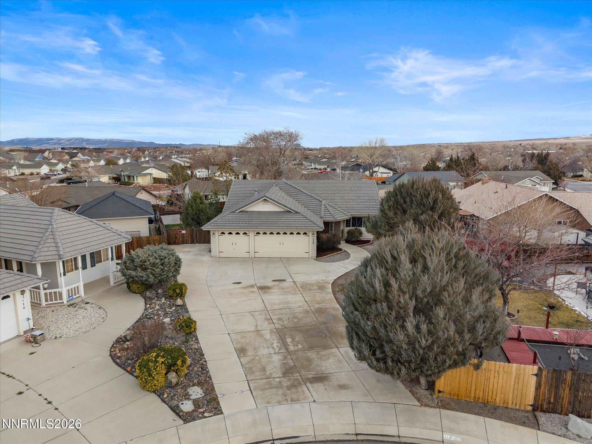 112 Alexander Court Fernley, NV 89408 - Photo 40 of 61 an aerial view of a house with large trees
