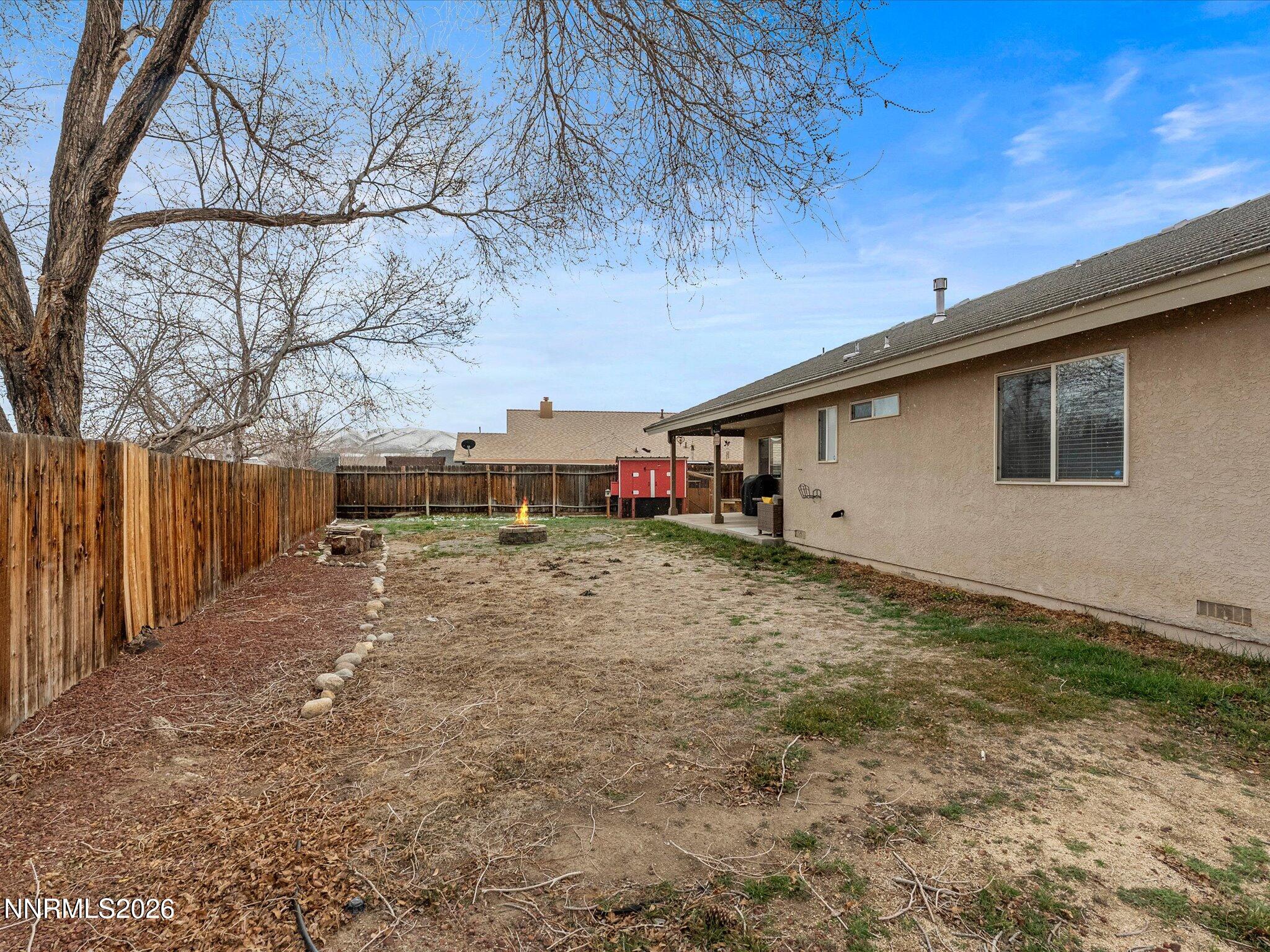 112 Alexander Court Fernley, NV 89408 - Photo 56 of 61 a backyard of a house with lots of green space