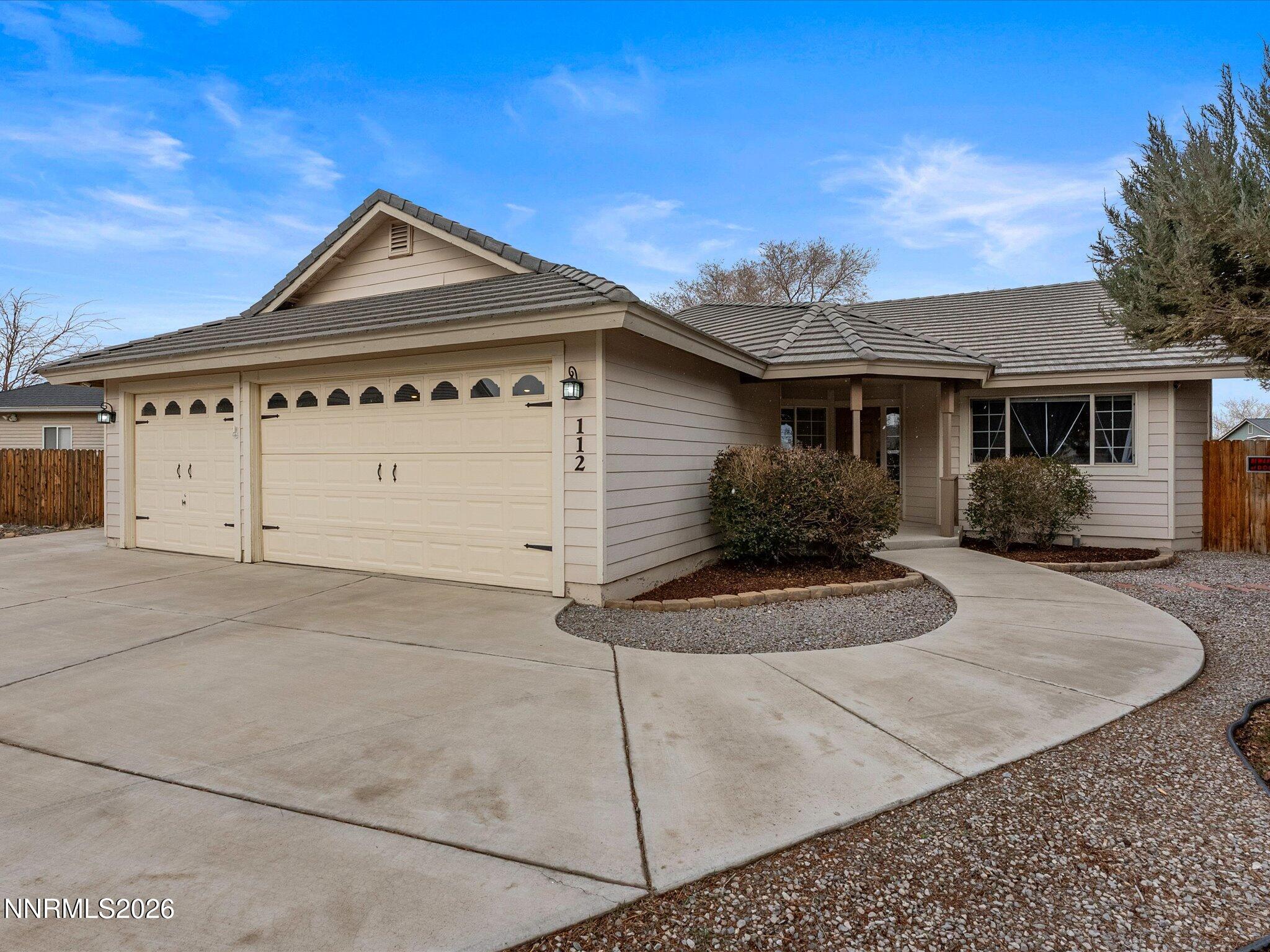 112 Alexander Court Fernley, NV 89408 - Photo 7 of 61 a front view of a house with garage