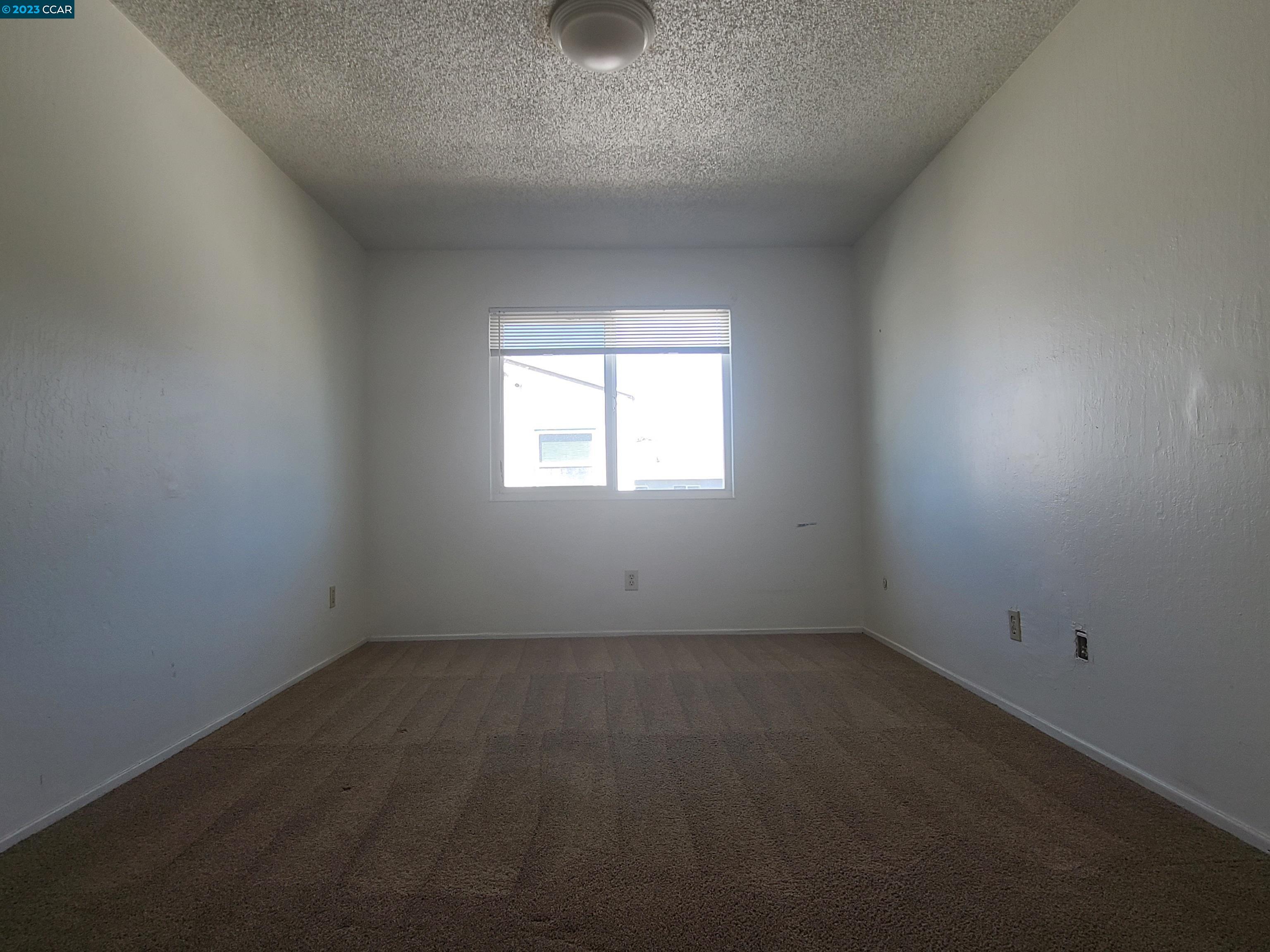 322 Vaqueros Avenue Rodeo, CA 94572 - Photo 6 of 6 an empty room with a window