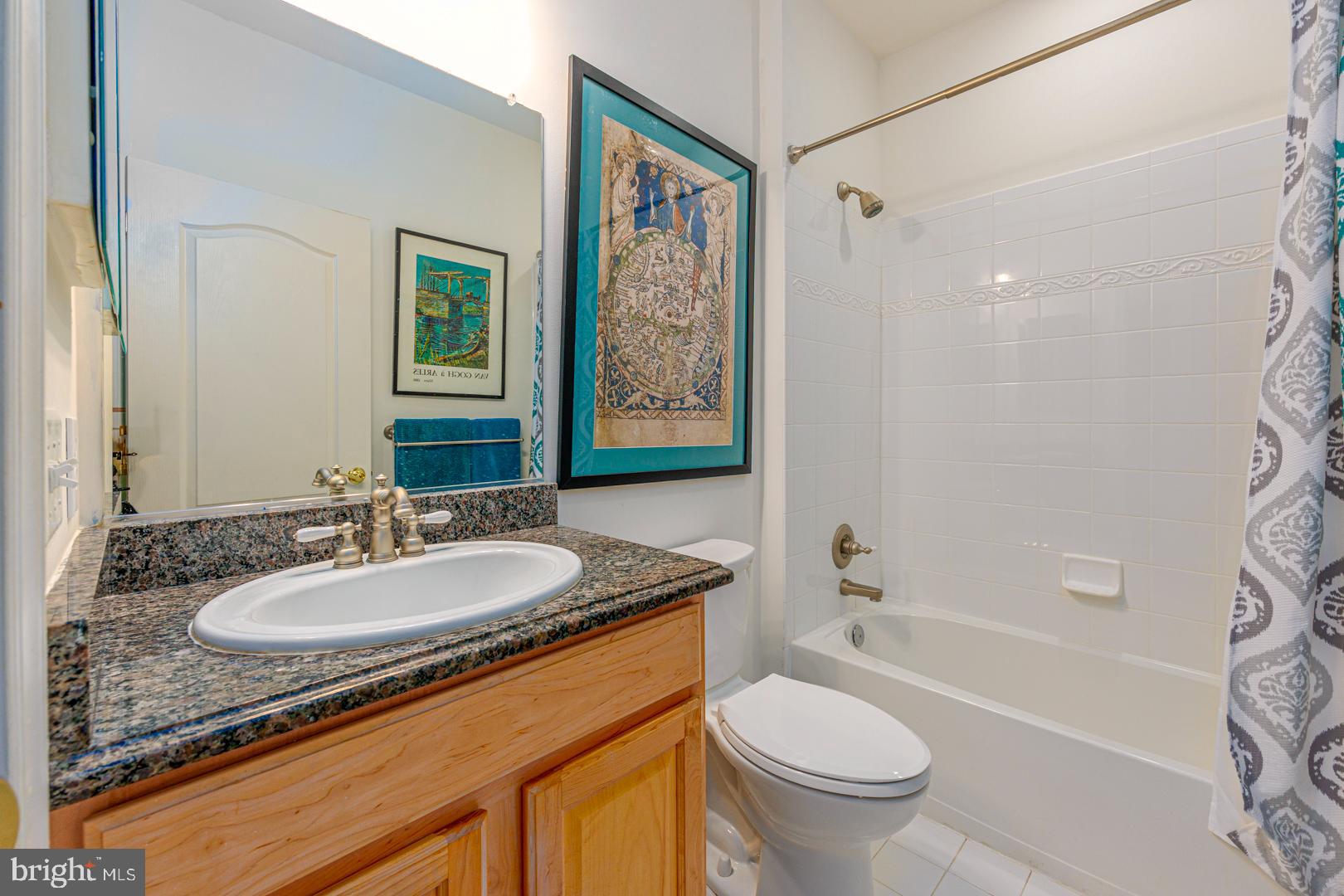 250 Concerto Avenue Centreville, MD 21617 - Photo 23 of 34 a bathroom with a granite countertop sink toilet and shower