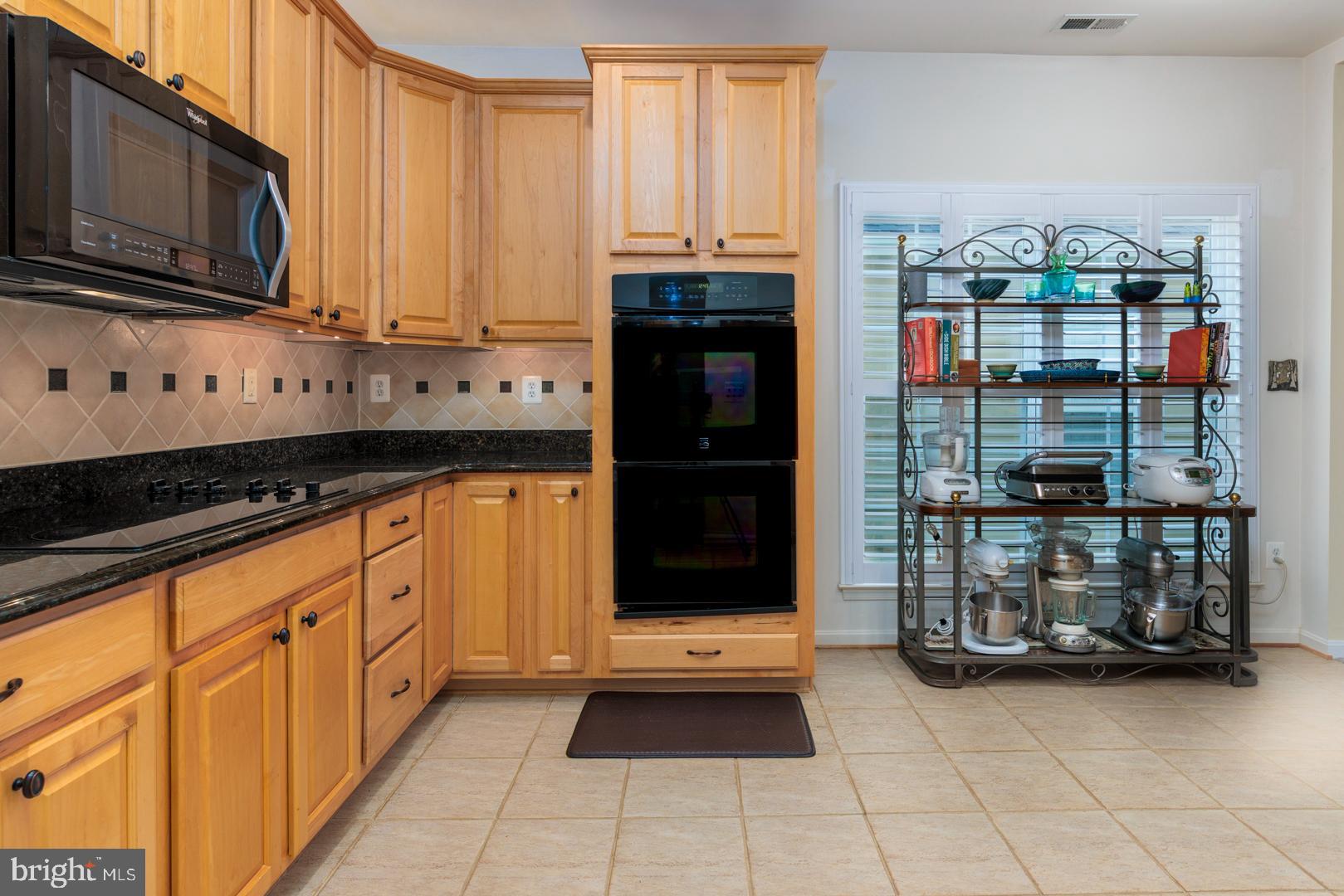 250 Concerto Avenue Centreville, MD 21617 - Photo 3 of 34 a kitchen with stainless steel appliances granite countertop a refrigerator and a stove