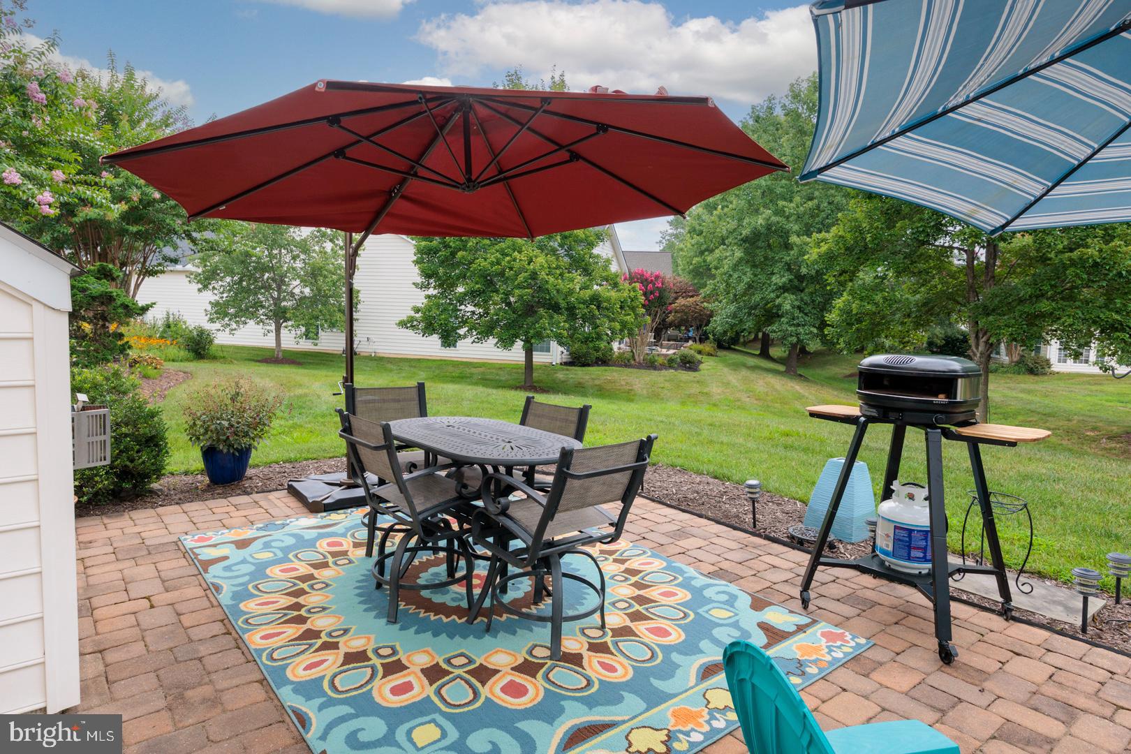 250 Concerto Avenue Centreville, MD 21617 - Photo 33 of 34 a view of a table and chairs under an umbrella in backyard