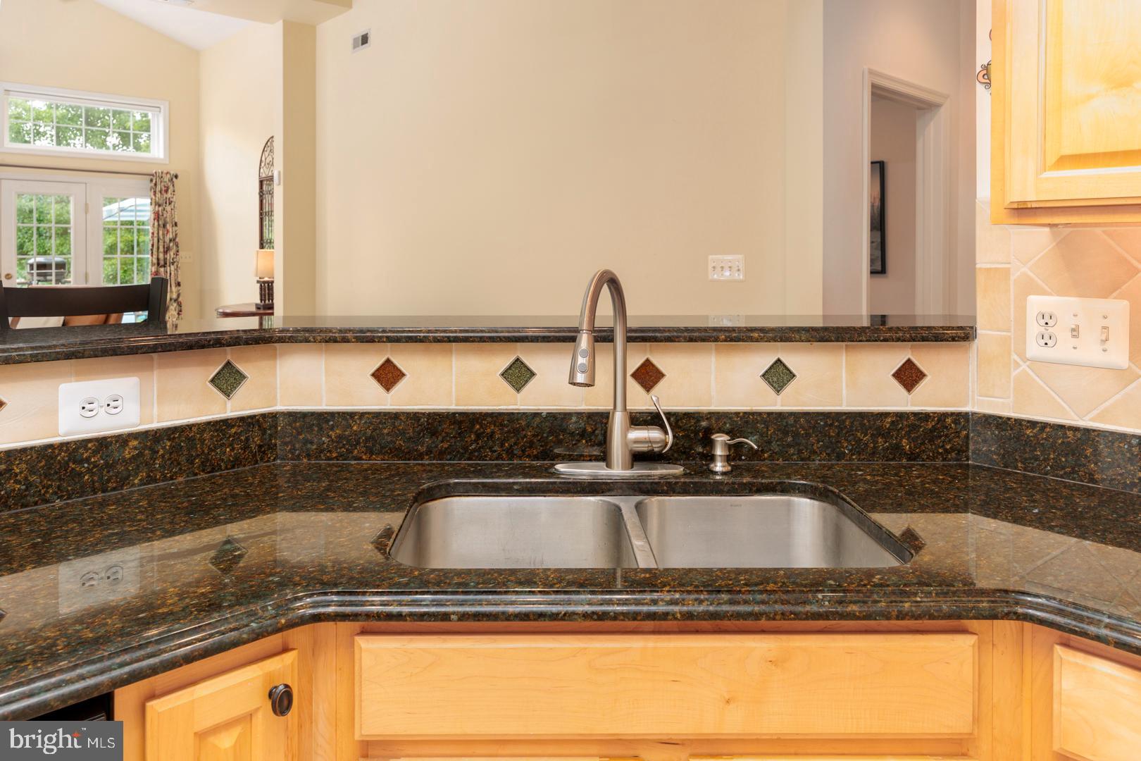 250 Concerto Avenue Centreville, MD 21617 - Photo 5 of 34 a bathroom with a granite countertop sink a mirror and a bathtub