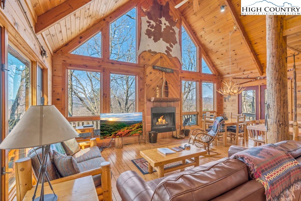 2095 Elk Ridge Road Ferguson, NC 28624 - Photo 13 of 34 a living room with furniture a fireplace and a large window