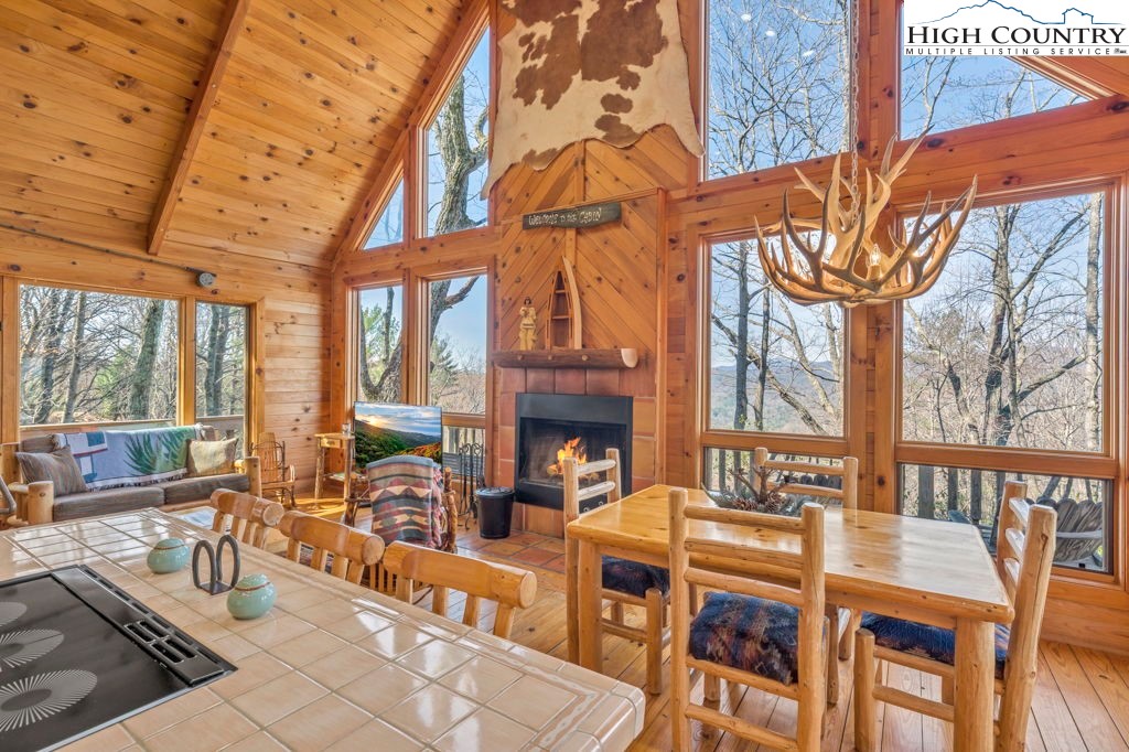 2095 Elk Ridge Road Ferguson, NC 28624 - Photo 18 of 34 a living room with furniture a fireplace and large windows