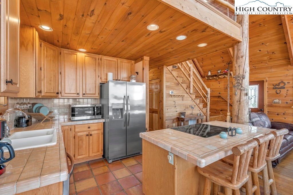 2095 Elk Ridge Road Ferguson, NC 28624 - Photo 20 of 34 a kitchen with a sink a refrigerator and cabinets